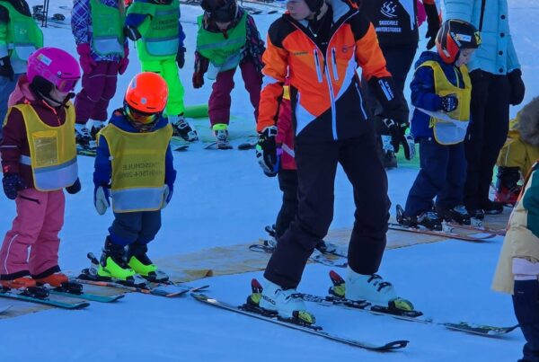 Ski instructor teaching kids balance and turning