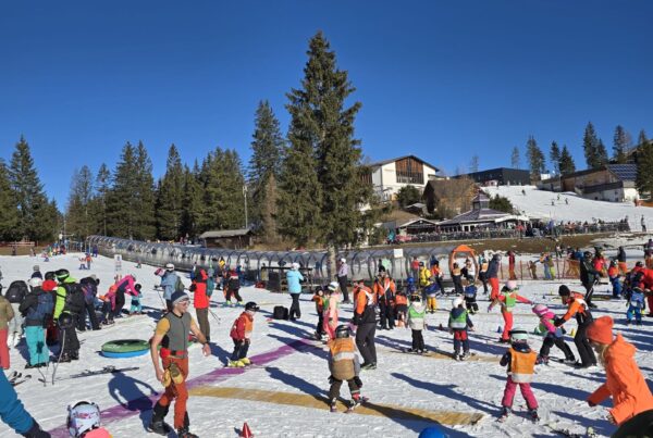 Skiers training on prepared ski slope on a beautiful sunny day